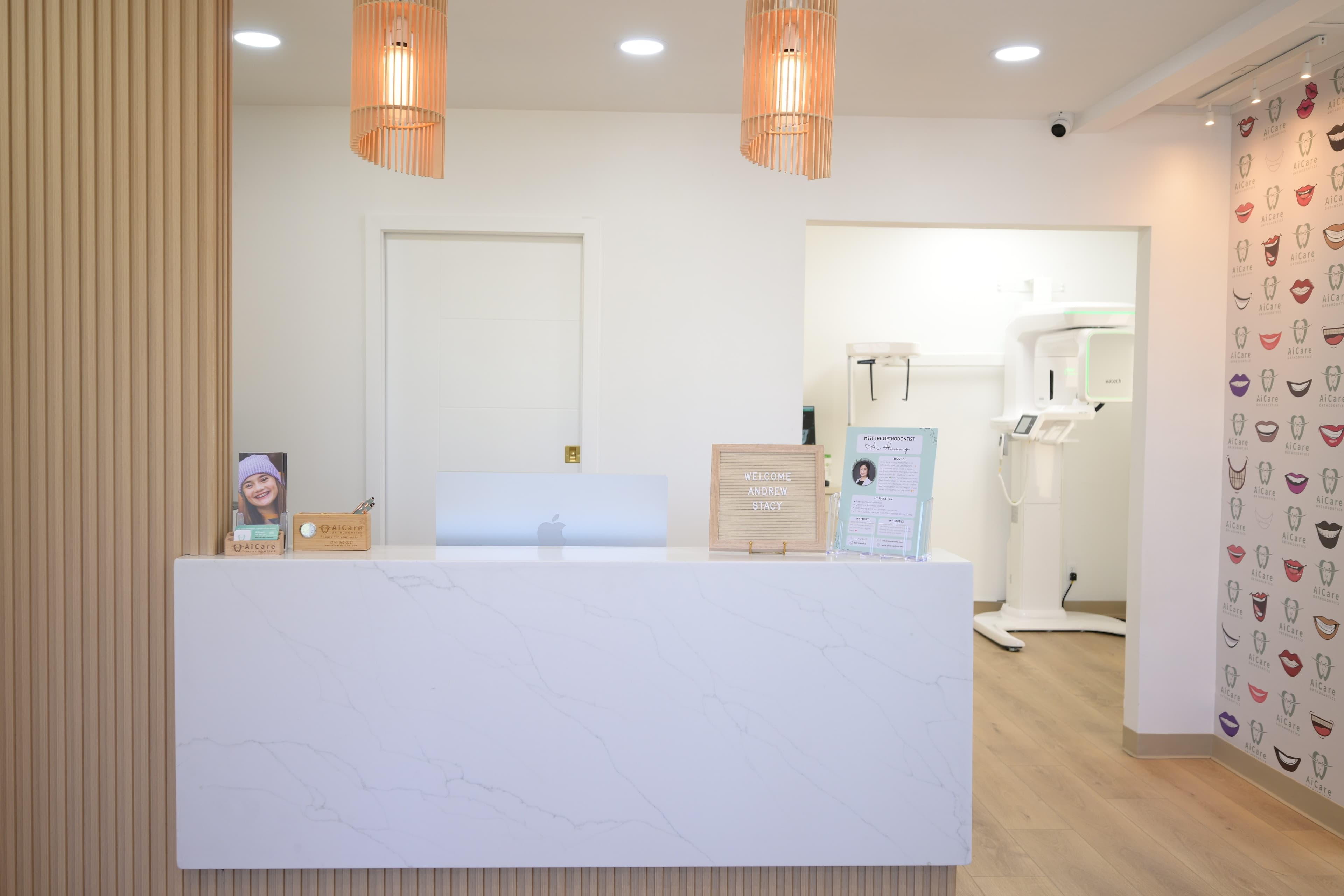 AiCare reception desk with wood paneling and pendant lights