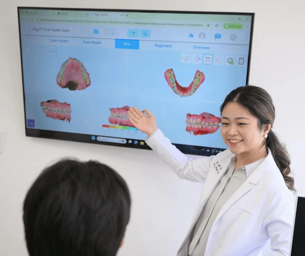 Dr. Ai Huang explains an iTero scan on a large screen in the Fountain Valley consultation room